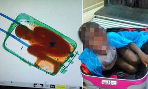 epa04737541 Handout picture provided by Spanish Civil Guard that shows the attempt by a Sub-Saharian immigrant aged eight years old in a suitcase trying to get in to Ceuta, Spain on 07 May 2015. The minor immigrant was caught due to the scaners in the border.  EPA/GUARDIA CIVIL / HANDOUT  HANDOUT EDITORIAL USE ONLY/NO SALES